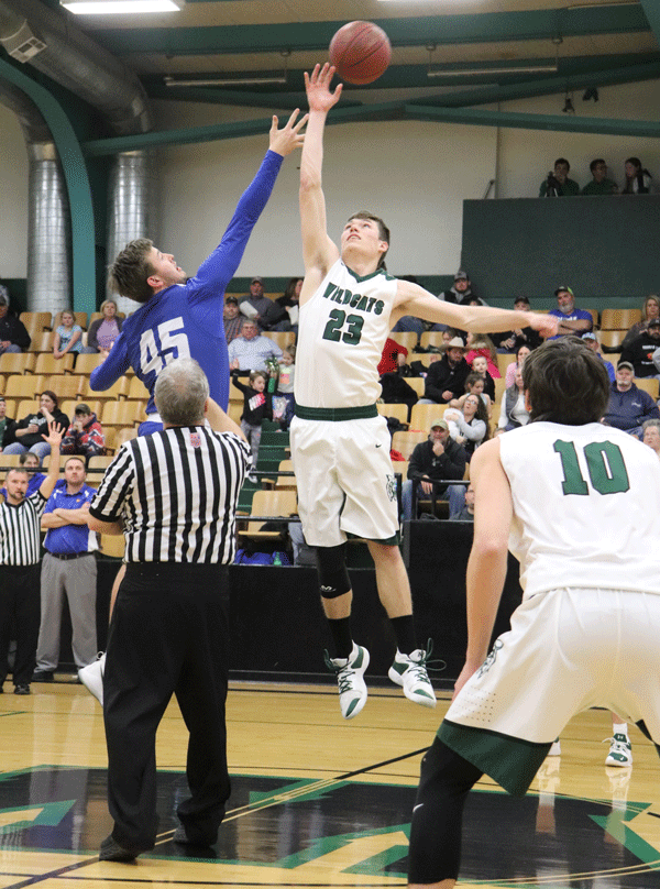 Senior Matt Luebbert starts off home game with jump ball against opponent from Climax Springs. The wildcats took the lead 73-42. 