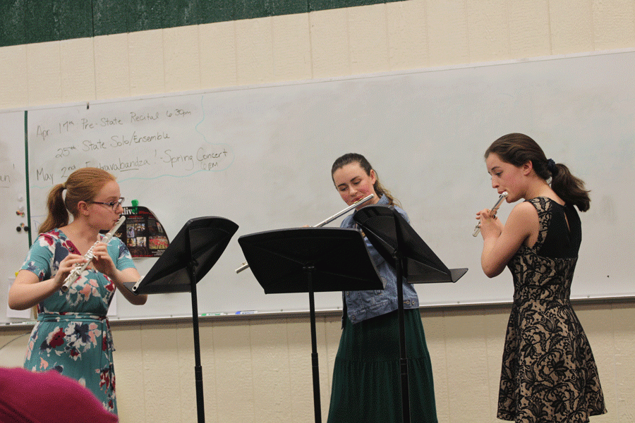 Junior Becky Petesch, sophomore Gabby Porter and senior Autumn Long practice their flute trio at the pre-state recital. 
