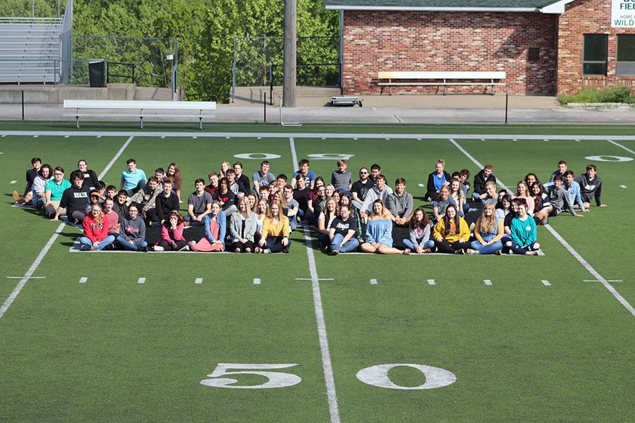 The Class of 2019 poses for a group photo at Warsaw High School on the Randy Morrow Field. Students assembled themselves in the shape of a W for the picture. 
