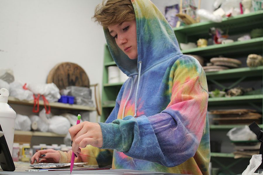 Senior artist Bonnie Davis works on a project in her third hour Art lll class. Davis enjoys designing tattoos for people.