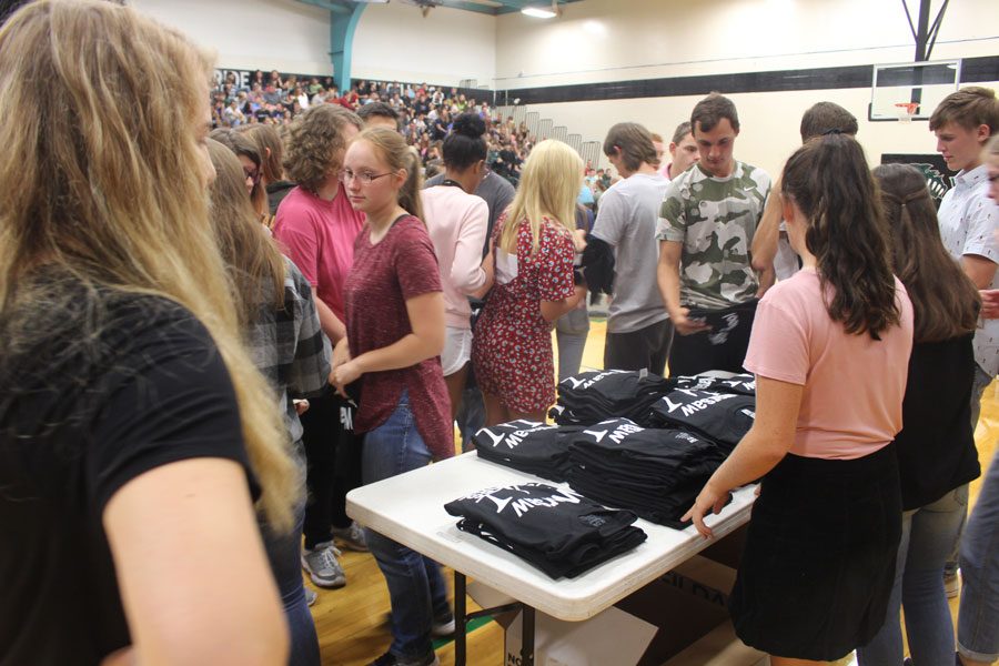 Seniors get their free Warsaw t-shirt. The junior class raised money through donations to offer free t-shirts to students.