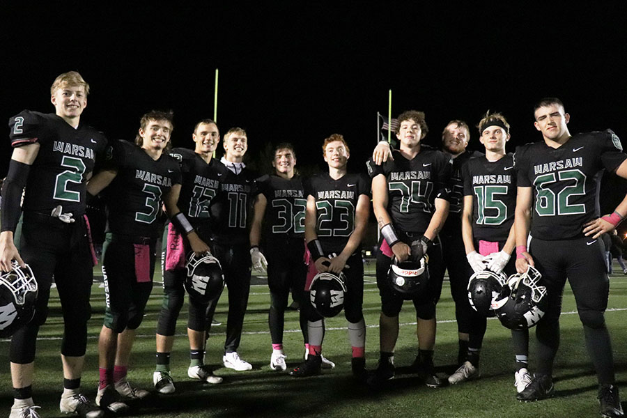 Seniors Grayson Gregrich, Chase Steiner, Matthew Couzens, Zach Chapman, Aidan Comer, Clayton Simons, Tristen Reynolds, Lane Bates, Chris Gemes and Austin Rosser gather for a picture after their pink-out game against Father Tolton. Warsaw beat Father Tolton 44-20.