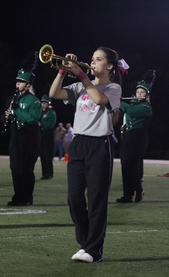 Freshman Emma MacWilliam performs during the band’s halftime show. MacWilliam is also involved in cheer as a flyer. 