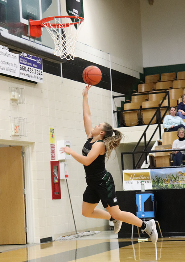 Sophomore Taylor Howe shoots a  layup. Howe plays as a point guard for the team.