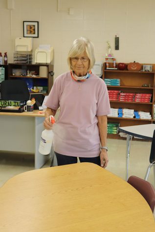 Custodian Linda Hiserote sprays down a desk after school to disinfect the classroom and prepare for the next school day. Custodians use a vital oxide spray to sanitize surfaces and a UV and to clean desktop computers. Hiserote says she couldn’t do it without the extra help from all the teachers.