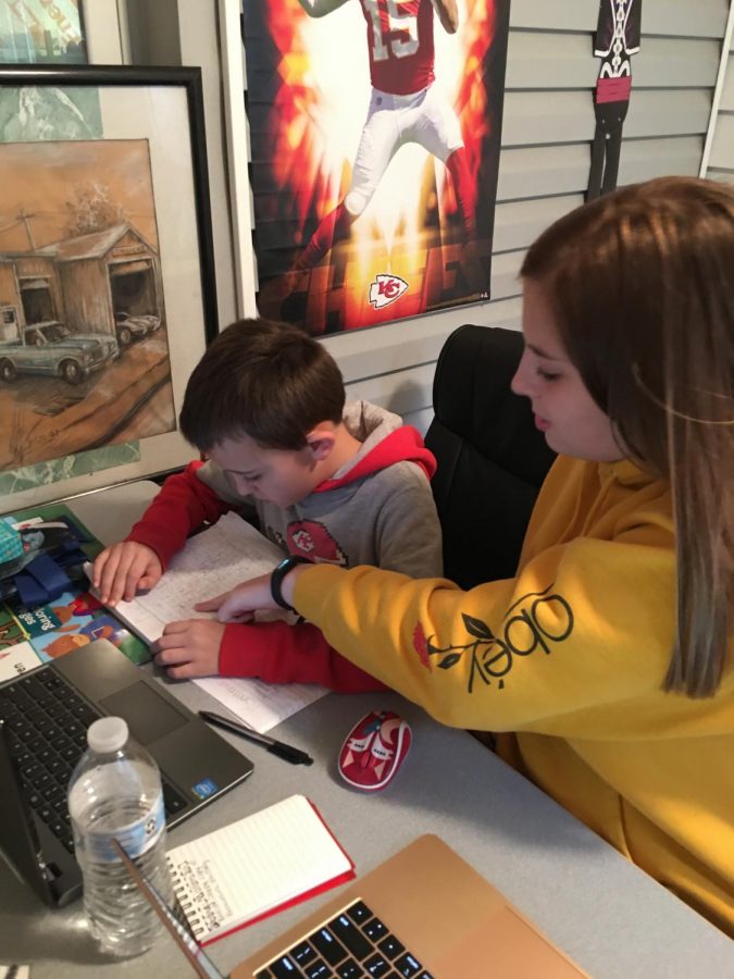 Sophomore Perrie Judd and fourth grader Marshall Judd work on their assignments for Launch. Perrie Judd joined the Launch program to protect her family. 
