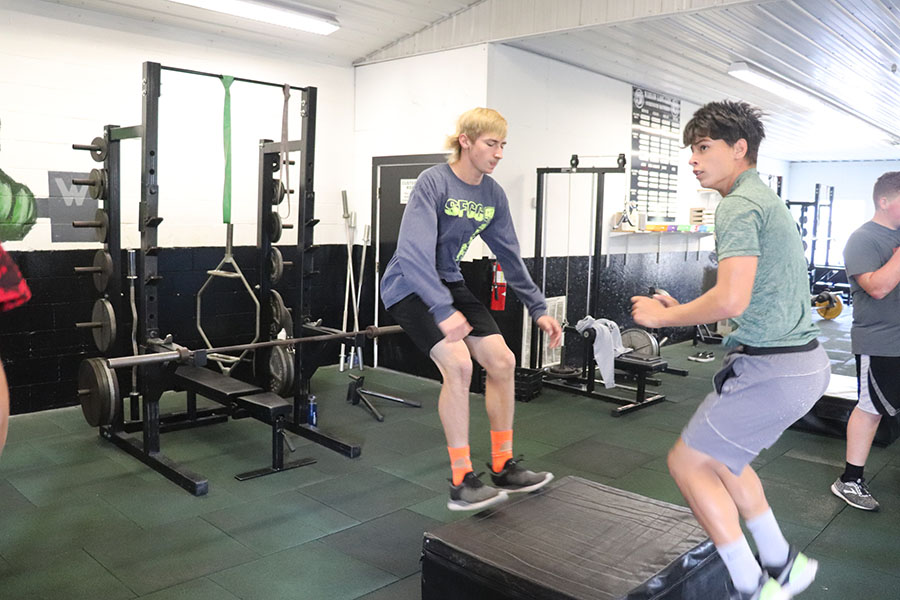 Seniors Zach Sharp and Justin Martin practice box jumps in weights class. Sharp is perfecting his skills for football season 