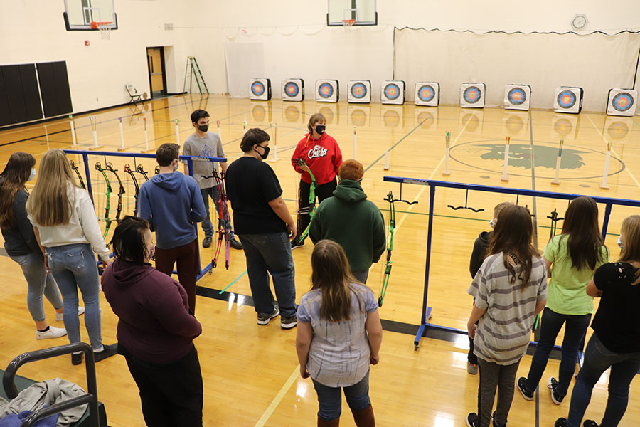 Coach+Jackie+Downing+explains+to+the+archers+the+safety+regulations+for+archery.+Students+must+wear+a+mask+while+they+are+shooting+and+stay+behind+the+bow+racks+when+they+are+done+shooting.