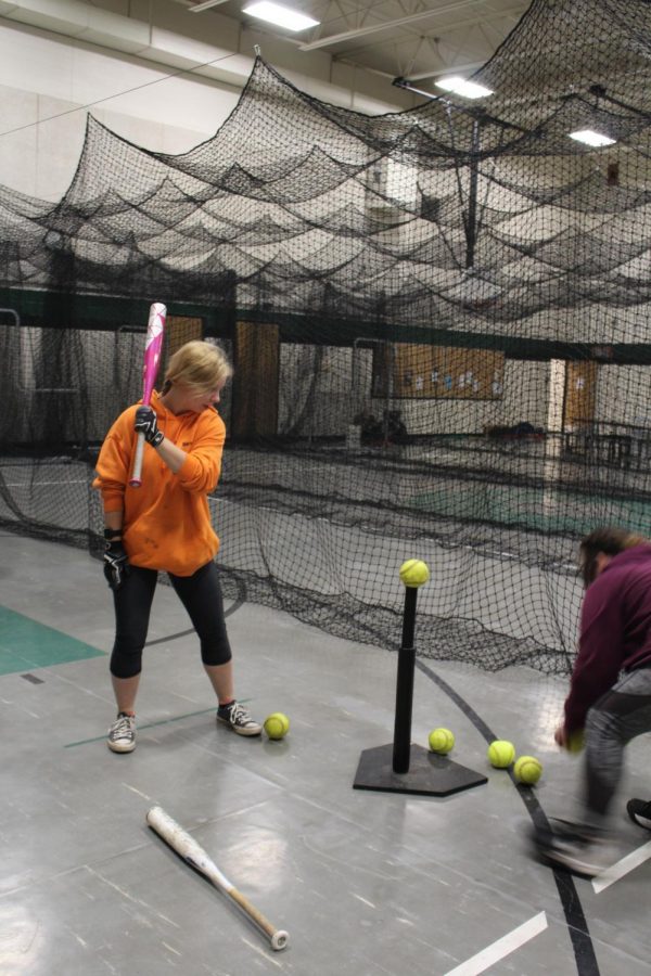 Sophomore Isabelle Edge prepares to swing at the ball during  after school softball practice. the team was hard to work in preparation for there first game on March 27.