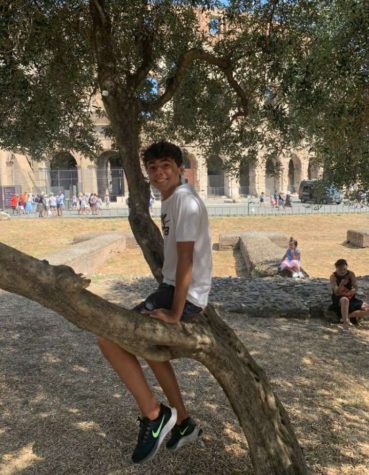 Senior Giovanni Pagliani sits in front of the Colosseum in Italy last year. 