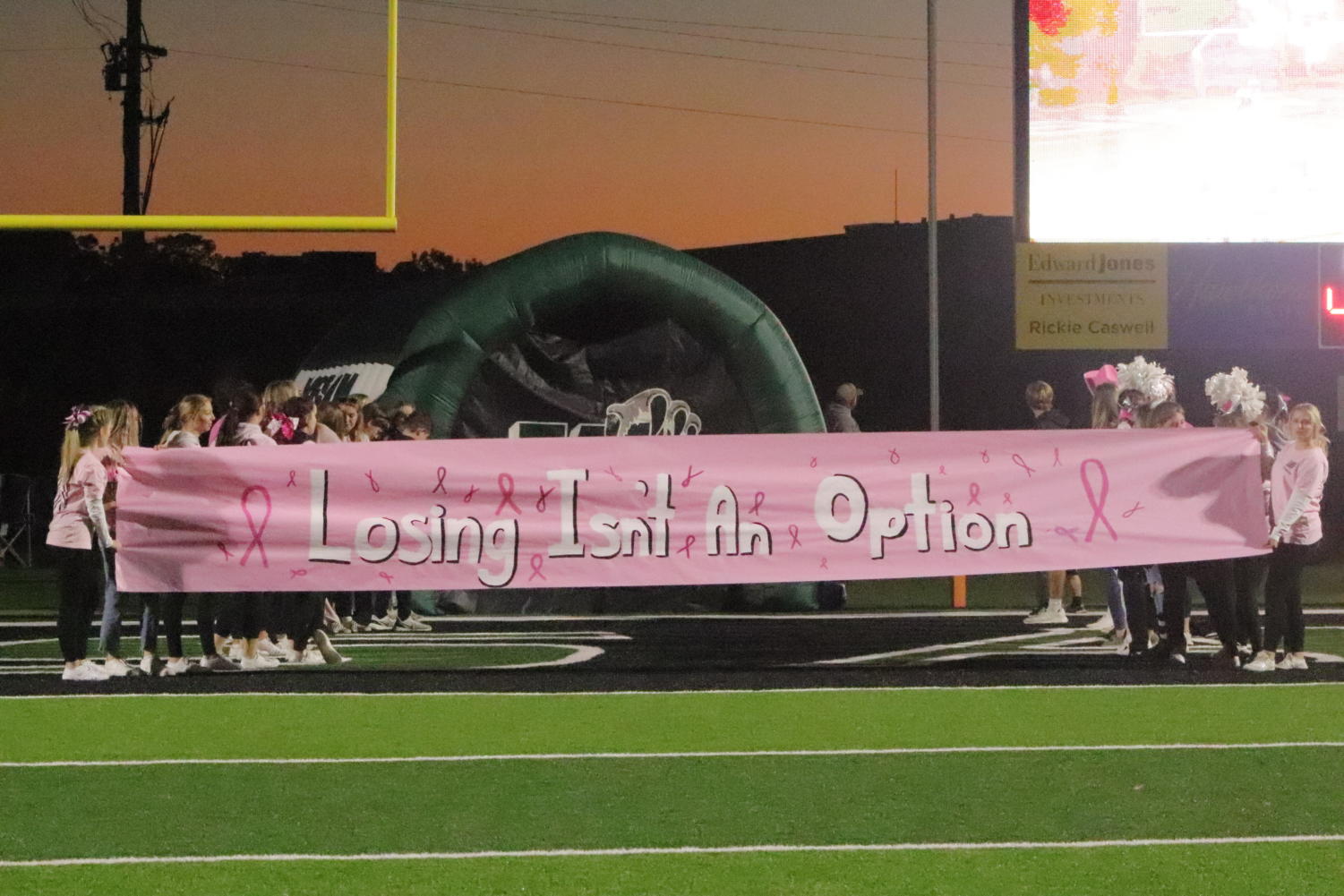 High school athletes support breast cancer awareness with pink