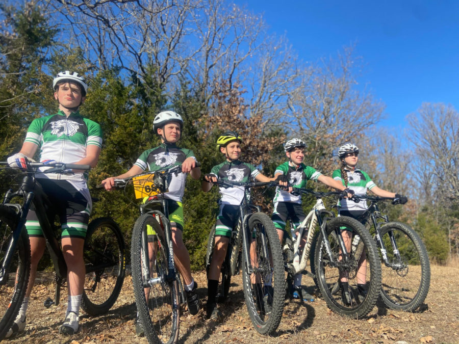 Sophomore Joe Vorce, seventh graders Gabe Nolen and Tommy Kaufmann, freshmen Jaxson Deckard and Keira Mostaffa pose for a picture during one of their practices. This is the first season for the mountain bike team.