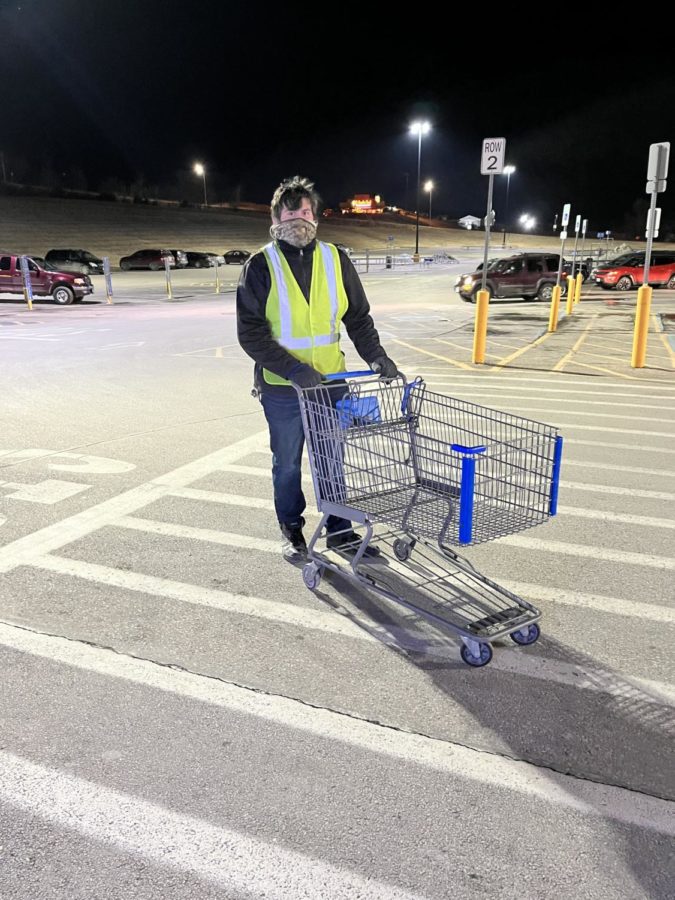 Senior Luke Martinez brings a cart back to the corral. Martinez has worked at Walmart for over a year now.