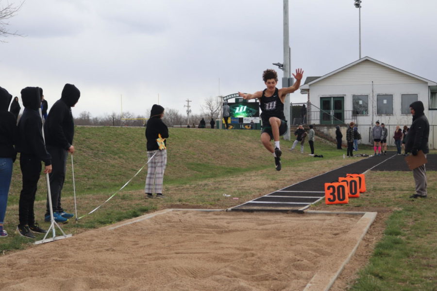 Senior Grant Chapman participates in the triple jump event at the Warsaw track meet. Chapman also participated in the 300m hurdles. 