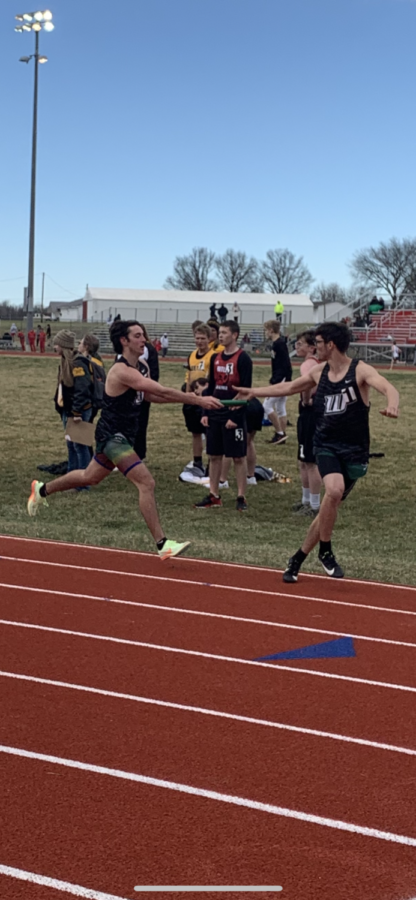  Junior George Montez hands a baton to junior Cameron Seevers in the 4x8 at March 25 in Butler. Their team earned first place.
