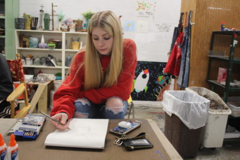 Junior Whitney Brown works in sketchbook during free time in Derek Nortons Art II class. Free days are the best because we can do whatever we want