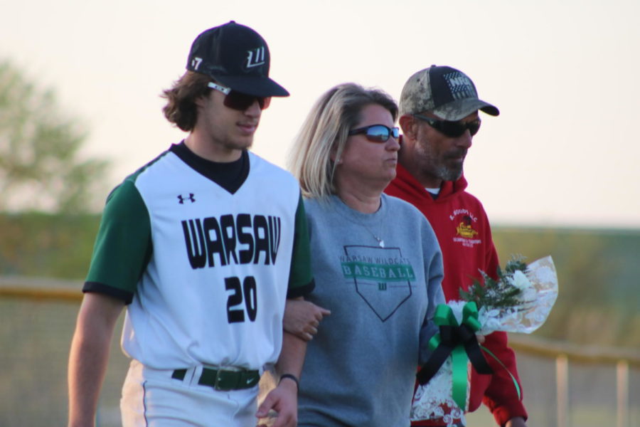 Second baseman James Kellner is escorted by his parents, Jesse and Eryn Kellner. James has played since he was four. 