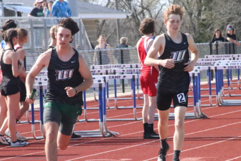 Junior George Montez runs ahead in the boys relay after getting the hand-off from sophomore Nate Banfield at the Cole Camp meet. The two qualified for sectionals in the 4x4 and 4x8 races.