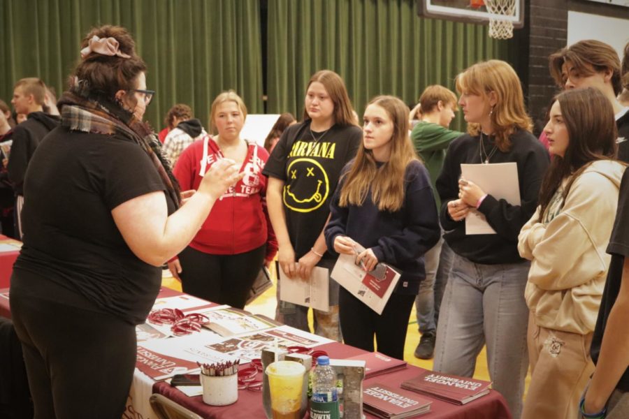 A+group+of+students+gets+information+from+Evangel+University+at+last+month%E2%80%99s+college+fair.+Some+seniors+have+already+received+acceptances+from+colleges+for+next+fall.