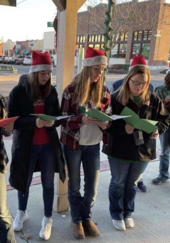 Juniors Josephine Kelsey, Grace Drake, and Dallas Steinhoff travel around town caroling. Drake hopes to study music in college and be able to share her love of music.