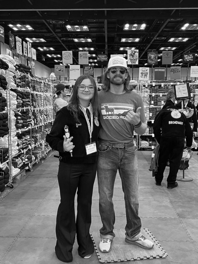 Sophomore Hannah Todd takes a photo with rodeo star and social media influencer, Dale Brisby, in the convention shop in Indianapolis, Indiana. 