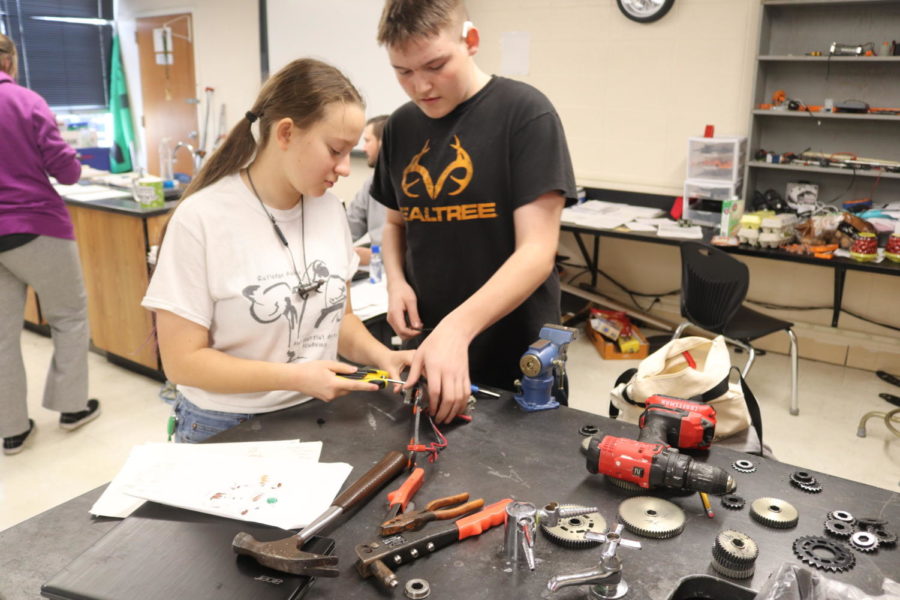 Sophomores Marissa Ricke and Draven Groves work on a project in Principles of Technology class. The class has different sections on coding, designing, cadding and building.