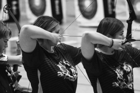 Ellie Murrell and Anna Siegal are aiming towards at the target in a archery shootout