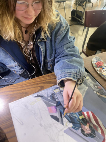 Junior Abbi Flinn works on a painting. Flinn loves to paint because its therapeutic and she can really express herself.