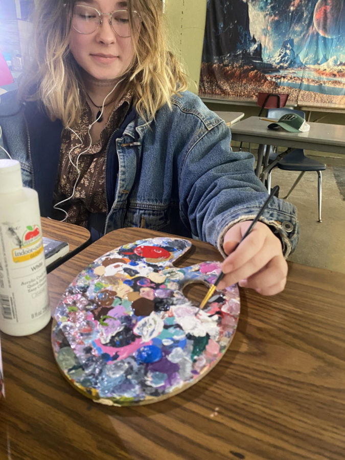 Junior Abbi Flinn works on a painting about 9/11. Flinn was making the piece for her government teacher Darren Daughenbaugh.
