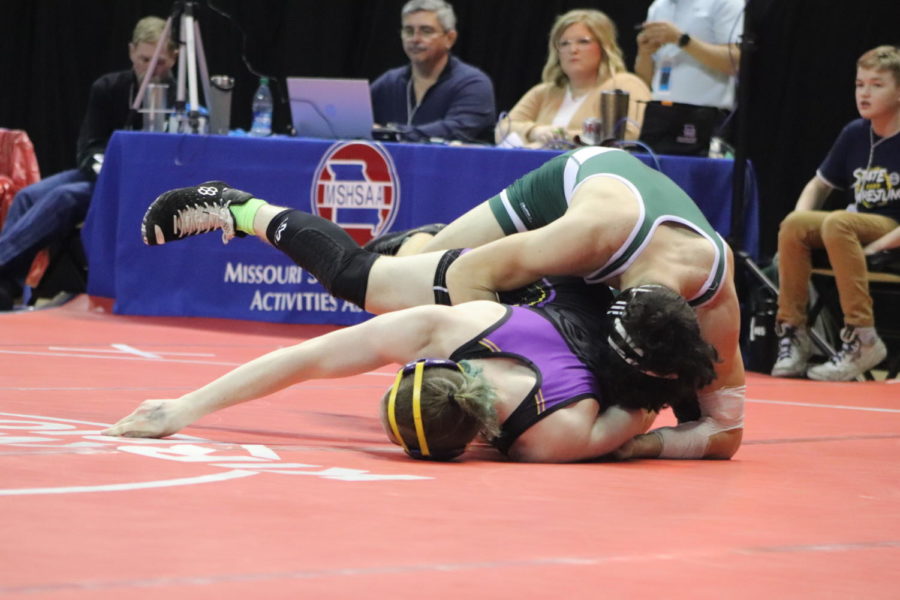 Freshman Josh Harvath attempts to turn his opponent at the state tournament. 