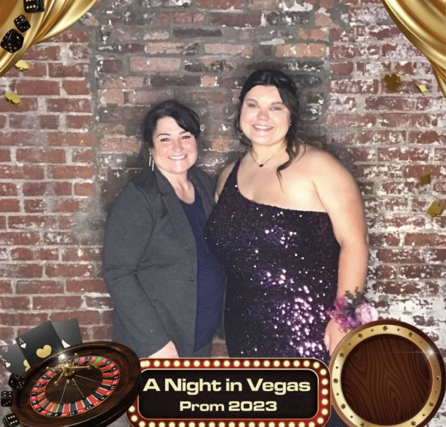 Senior Abi Feltrop taking a picture with her favorite teacher Mrs. Pate at prom. 