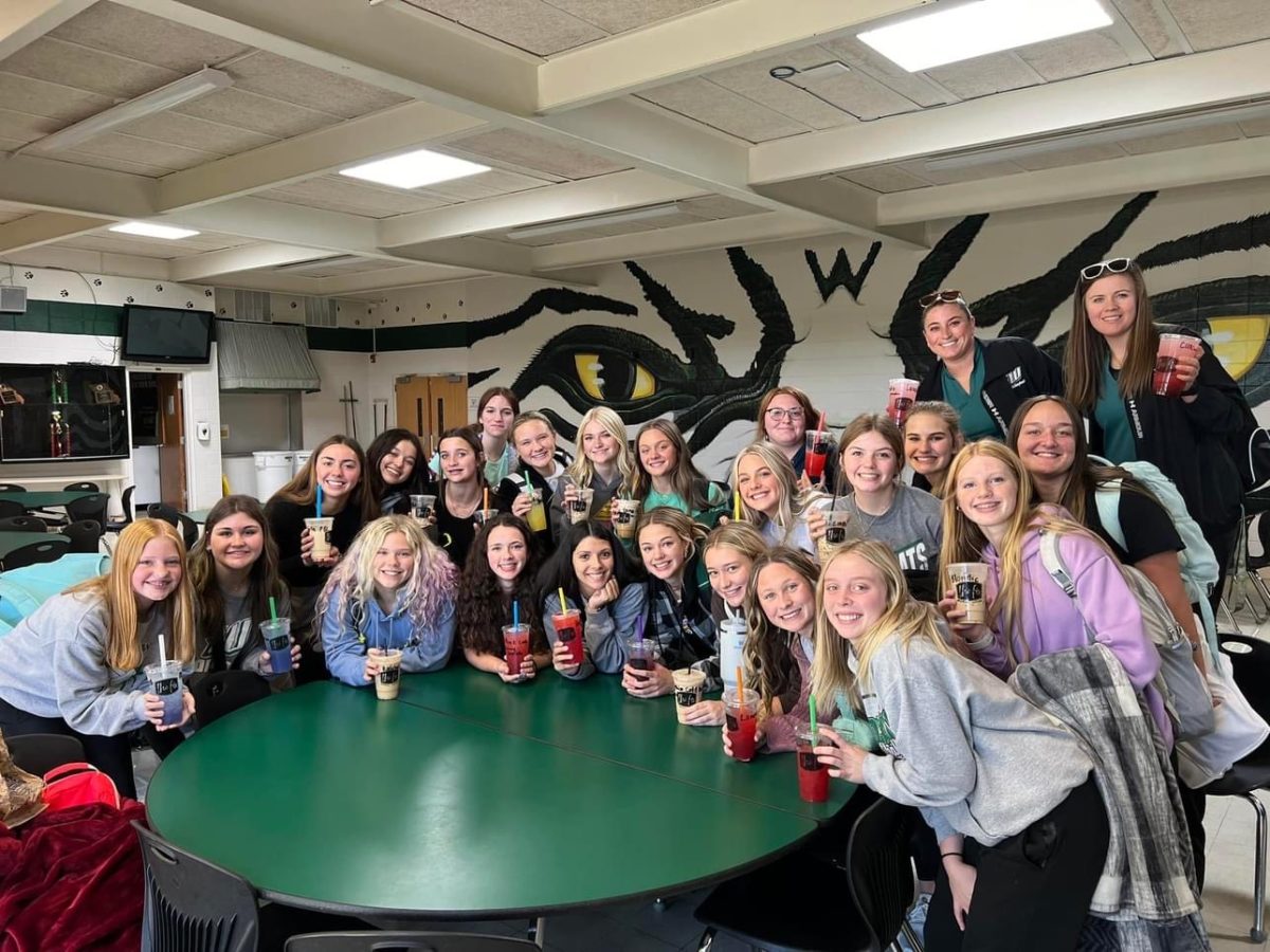 The volleyball team take a picture with their drinks from The Fix. The Fix donated all the drinks to support the girls before they were sent off to the first round of districts. 
