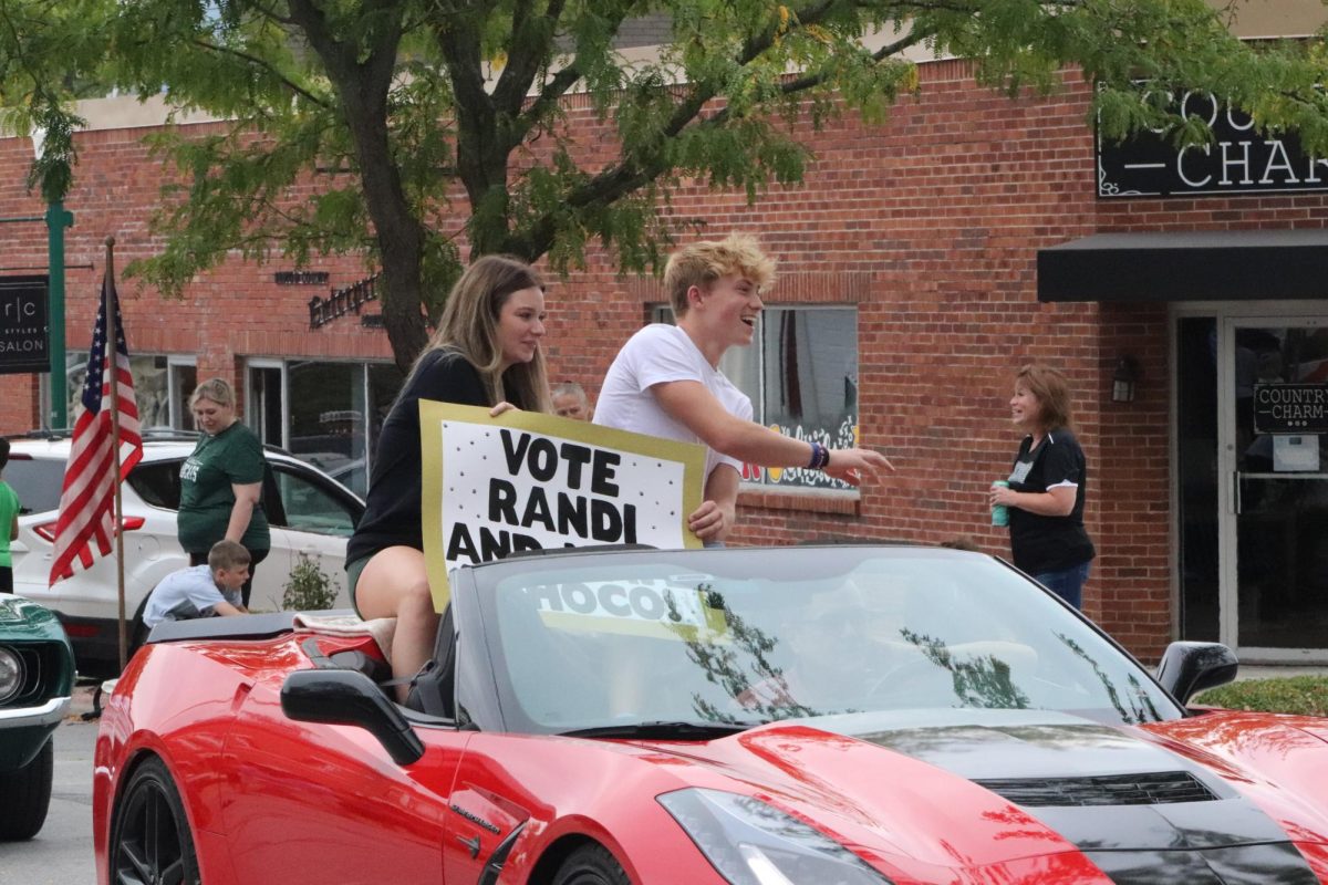 Seniors Randi Buchholz and Nate Banfield throw candy from their candidate car. I didnt like the parade being moved to Monday. It felt different and I dont think the hype was there like it wouldve been if we were to have had it on Friday like normal, Buchholz said.