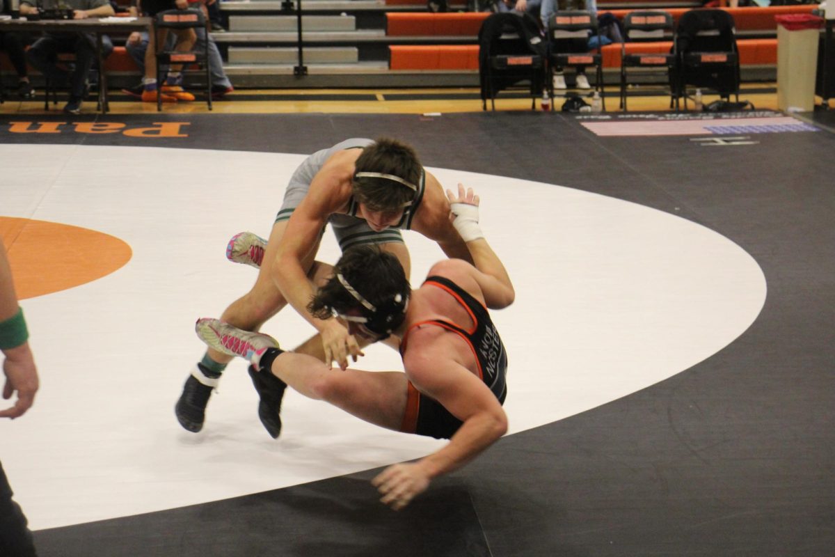 Junior Drake Murrell attacks his opponent to get him on the ground during the Knob Noster tournament. Murrell finished 3rd in the 165 weight class.
