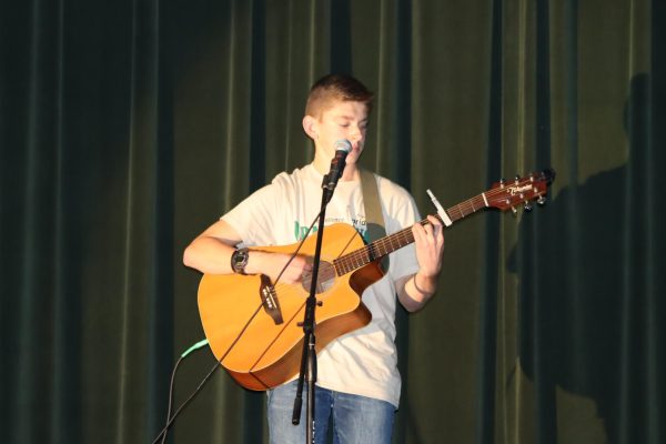 Junior Jaxson Deckard sings a cover song during the school talent show “Showstoppers this fall.
