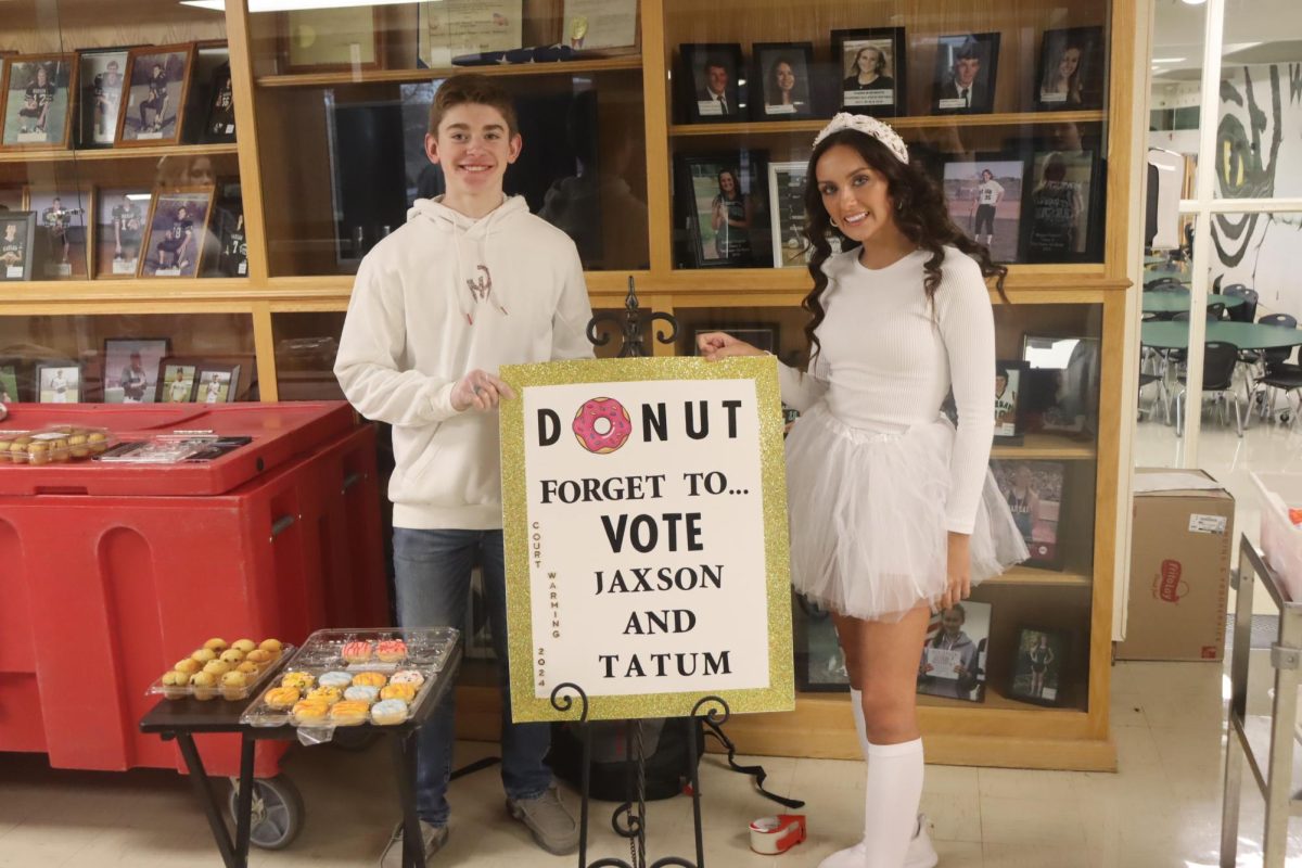 Junior candidates Jackson Deckard and Tatum Bohl present their candidacy by passing out donuts and cupcakes at the beginning of first hour. “We passed out a bunch of candy and snacks, while having a positive attitude and telling people to vote for us,” said Bohl.