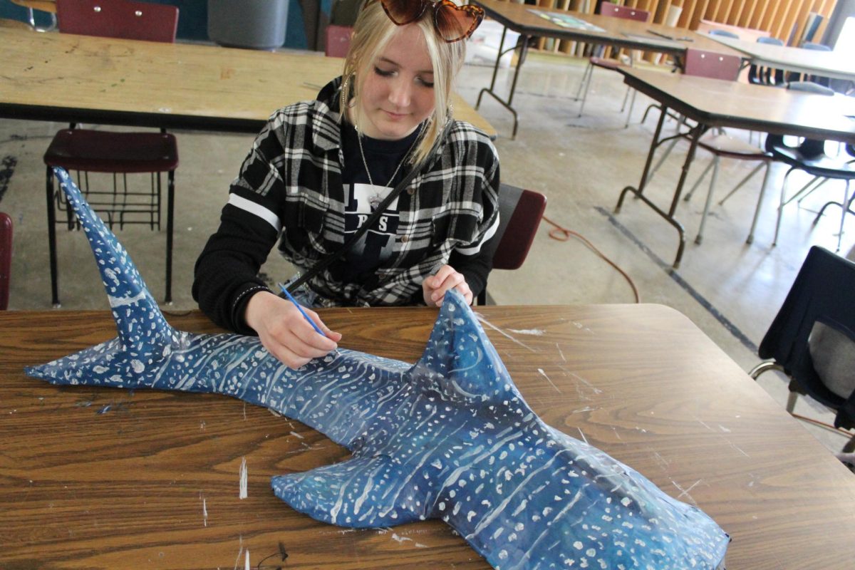 Freshman+Adele+Anderson+admires+her+whale-shark+sculpture+that+she+finished+first+quarter.+Art+teacher+Derek+Norton+has+recognized+her+talent+and+interest+in+visual+arts.