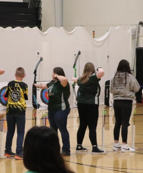 Sophomores Leah Miller and Amarillo Martinez shoot at the Smithton archery tournment. Miller managed to get her personal best this season