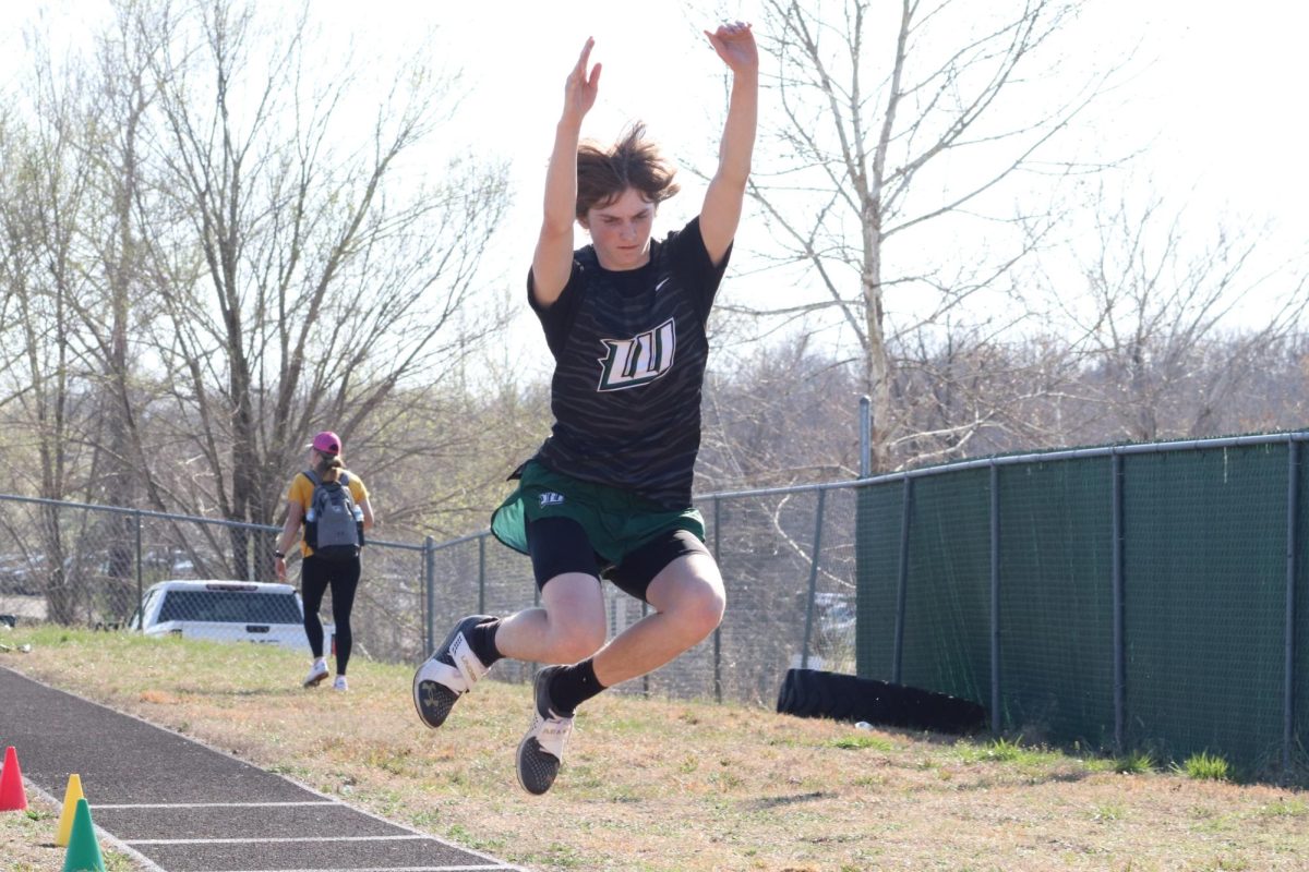 Fisher Love jumps the triple jump last year at a meet. Love also is jumping this event this season. 
