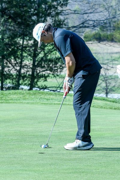Senior Carson Bonner putts for par at the Shawnee Bend golf course during a home match. The golf team came away with a win against Versailles on April 4 on home turf.