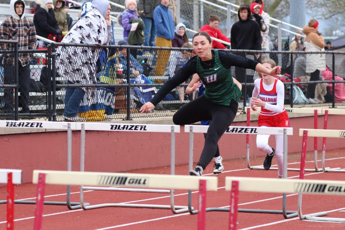 Senior Angela Konopasek jumps the 100m hurddles at Stockton on April 2. 