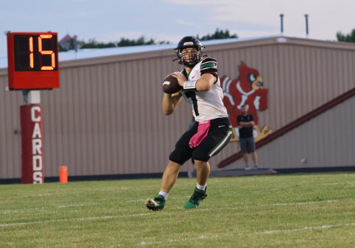 Senior quarterback Garrett Ferguson drops back to make a pass during the Lawson game. They won against Lawson 33-0 on August 30.