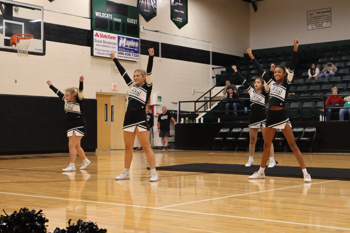 Junior co-captain Jovi Robertson and freshman Addison Hill finish the team's homecoming routine. The team used the same routine to compete in the regional contest and qualify for state.