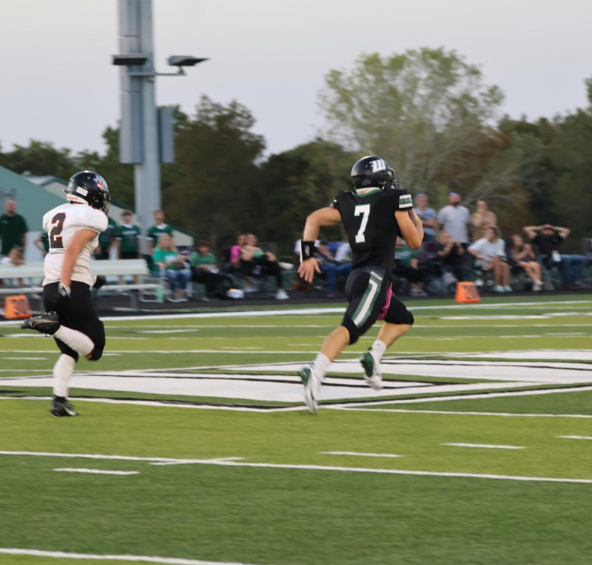 Senior quarterback Garrett Ferguson runs for a first play touch down. He scored the first touch down of the night against Sherwood on Sept. 20.