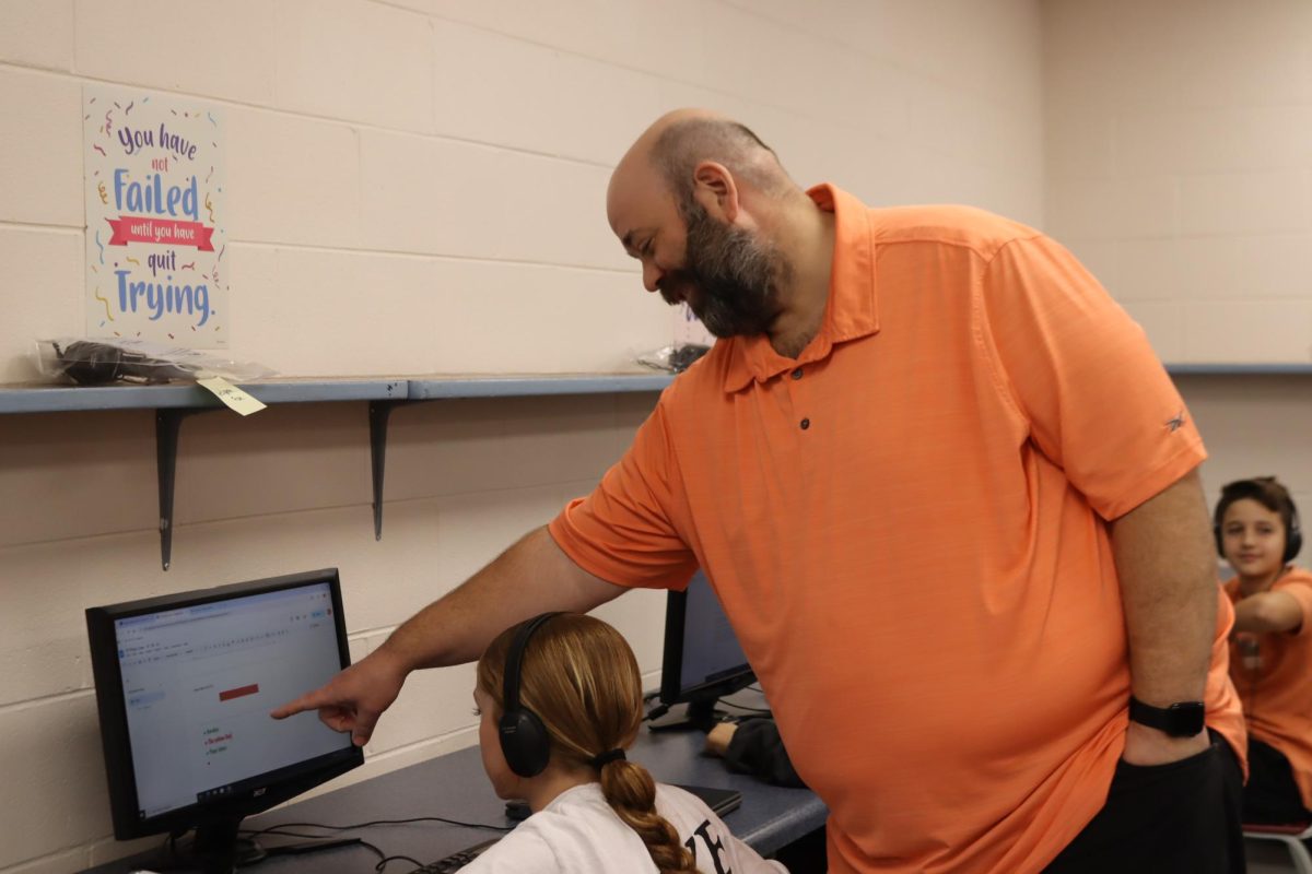 Matt Dove teaches his middle schoolers during computer literacy. This year he switched to Business.