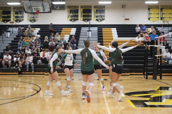 Varsity Ladycats celebrate after sophomore Maylee Slavens gets a kill.