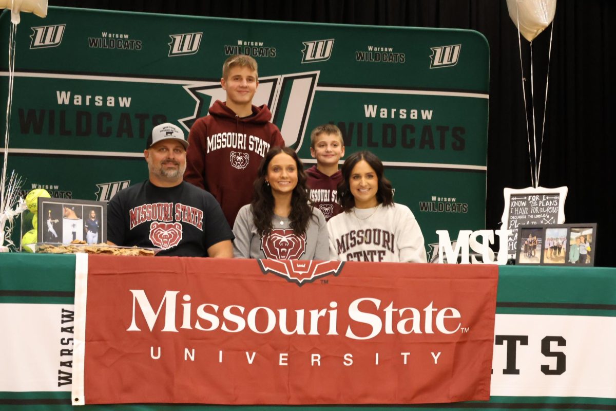 Senior Brylee Brewster gathers with her family for a picture, as she signs her letter of intent. “It was such a bittersweet day, I’m very thankful for all of the support that surrounded me.” Brewster said. 