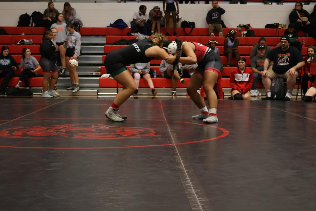 Freshman Bella Ramirez wrestles her opponent. Ramirez went 2-0 at the Butler Scramble. 