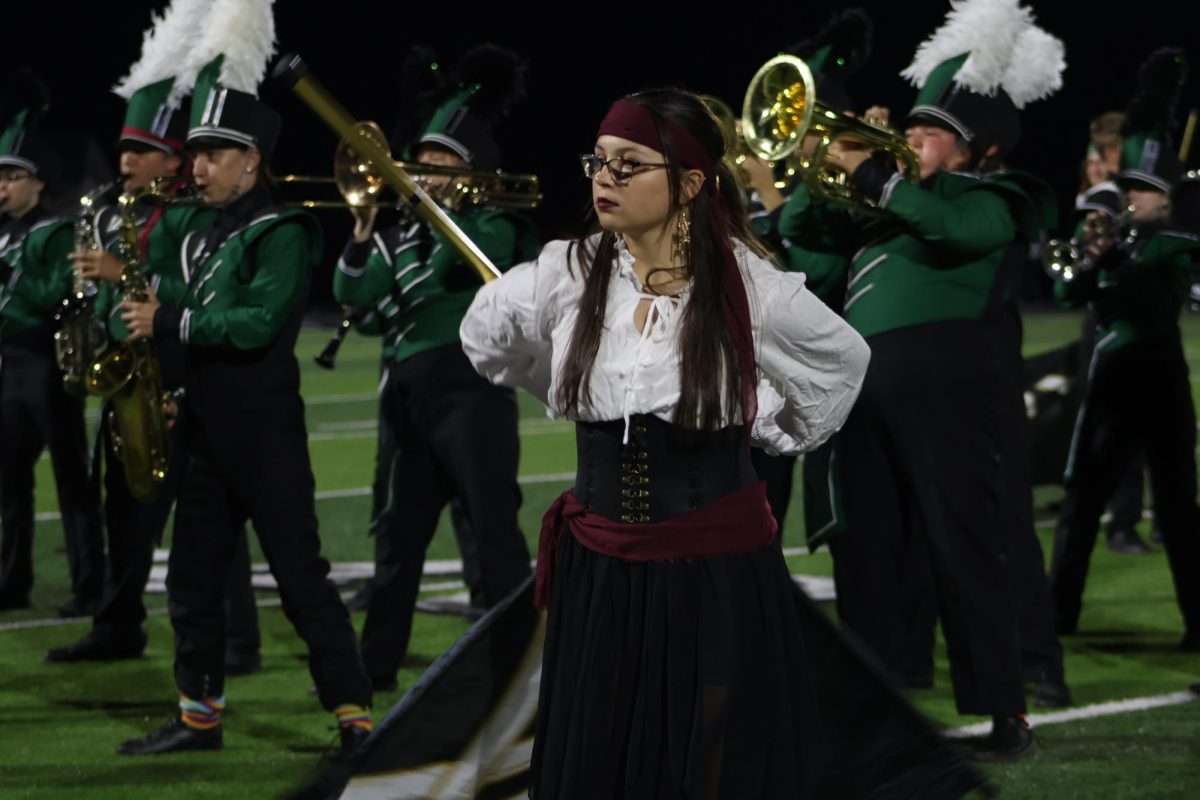 Sophomore Natalie Koenig performs at halftime with the band. She was doing her routine to The Pirates of the 