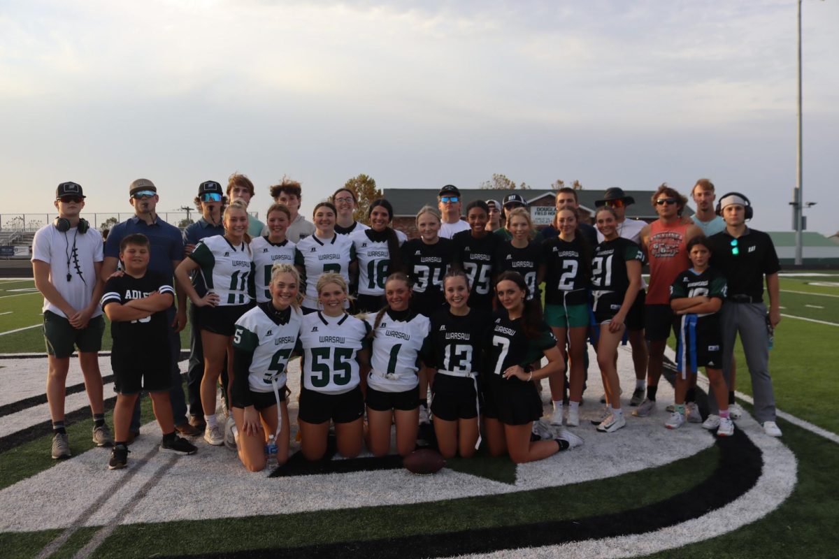 The teams get together for a picture before heading to the locker room for the pre-game pep talk. They included: (front row) sophomore Maylee Slavens, junior Kaleby Stevenson, Tanna Howe, freshman Braylee Cunningham, senior Tatum Bohl; (second row) 5th grader Henry Adler, sophomore Mady Reimund, Alenah Yoder, junior Jessie Bilderback, Hailey Ferguson, freshman Alyssa Boyd, Addison Hill, Amelia Roberts, senior Keira Mostaffa, Brylee Brewster, 5th grader Kylie Ferguson; (back row) juniors Brennen Slavens, Josh Harvath, Ryan Fajen, Ayden Burdick, Luke Henderson, sophomore Jenna Gerken, seniors Kendall Bagley, Shane Poyser, Dakota Todd, Trent Downing, Drake Murrell, Jayce Depriest, Logan Gemes, and Garrett Ferguson. 